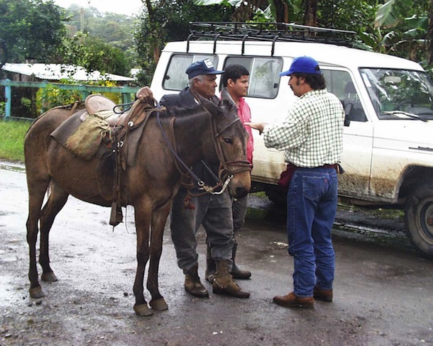 Sigifredo Marin in roadside land negotiations with landowner, his son, and his mule